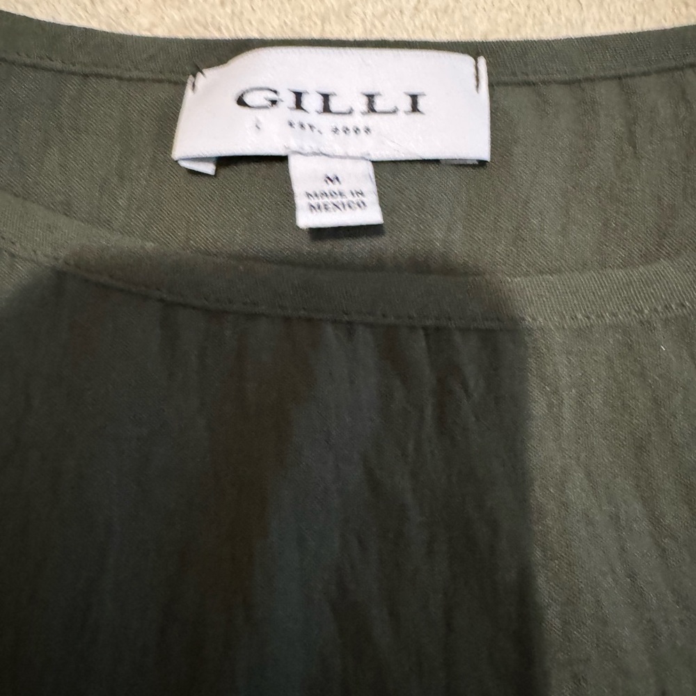 Gilli sleeveless top in dark green with front knot. Rayon and size Medium